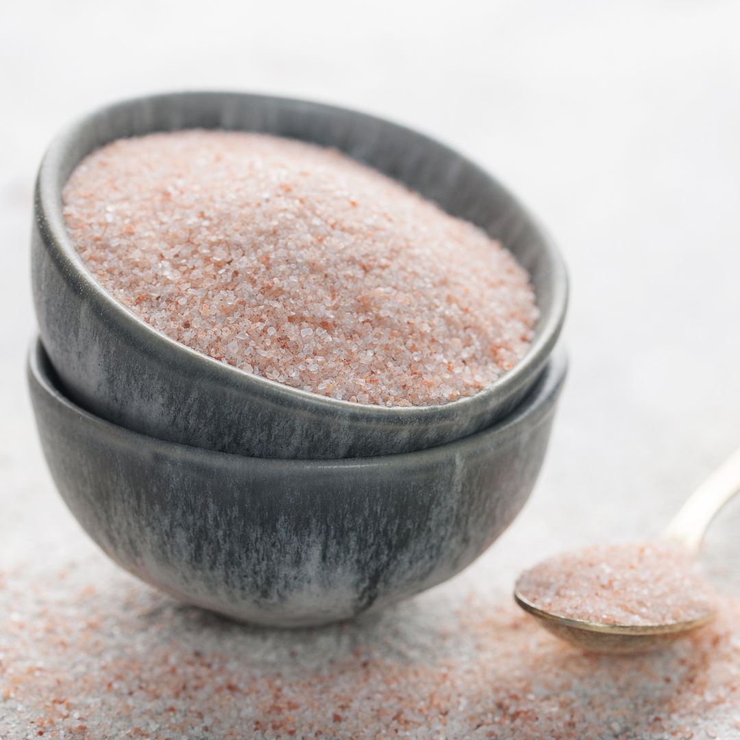 a bowl of white powder, sodium bicarbonate, a dry ingredient for use in cosmetics especially bath bombs