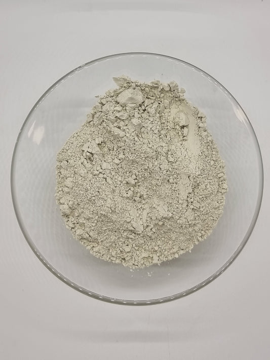 glass bowl containing fine off white clay powder
