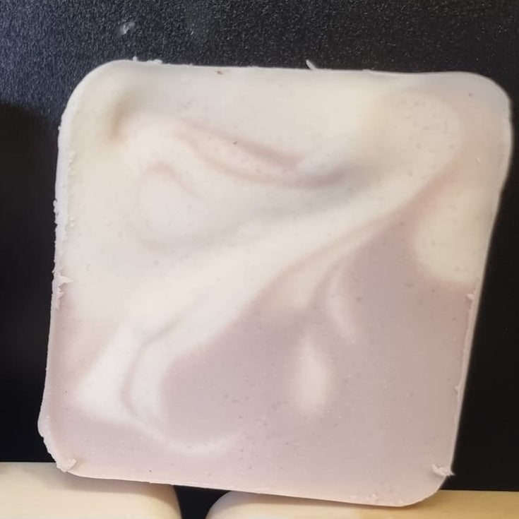 CP soap made with purple clay showing a light pink to purple swirl with a creamy white swirl